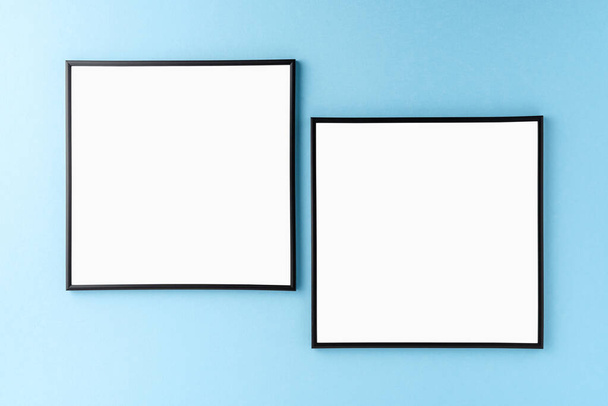 Mockup of two empty photo frames on blue background. Home decoration - Photo, Image