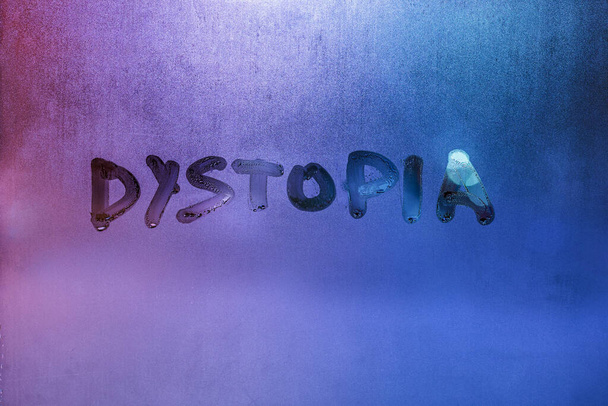 la palabra distopía escrita a mano en la superficie de cristal de la ventana húmeda - Foto, Imagen