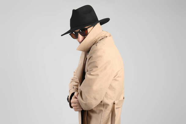 Exhibitionist in coat and hat on light background - Photo, Image