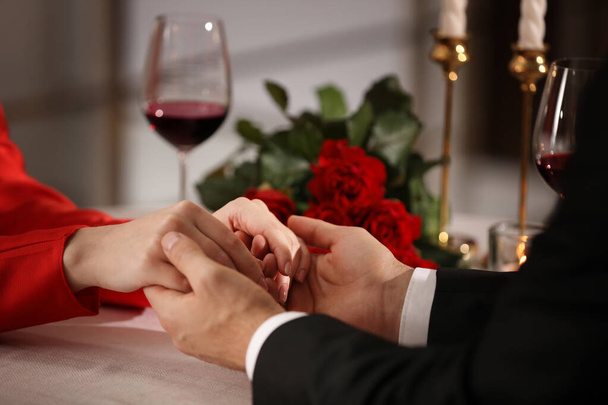 Couple having romantic dinner on Valentine's day in restaurant, closeup - Фото, изображение