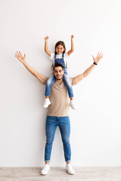 Cheerful Man Riding Excited Daughter On His Shoulders - Фото, изображение