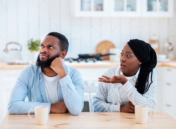Annoyed Black Man Listening Complaints From Wife In Kitchen At Home - Φωτογραφία, εικόνα