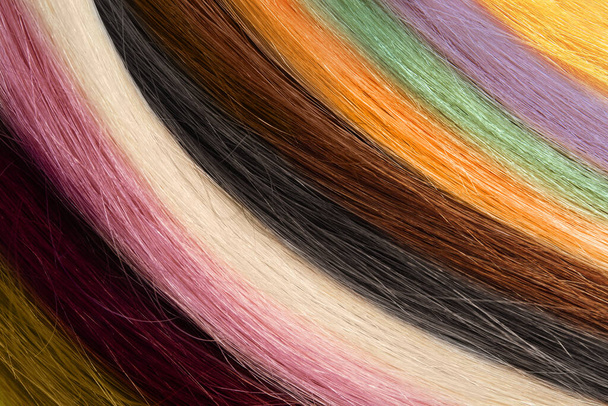 Strands of different color hair as background, closeup - Fotografie, Obrázek