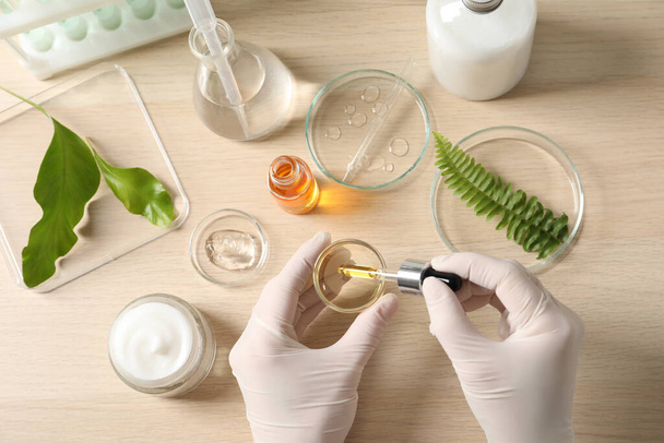 Scientist making cosmetic product at table, top view - Foto, Imagem