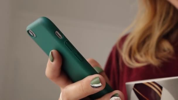 a womans hand with a beautiful manicure uses a phone - Footage, Video