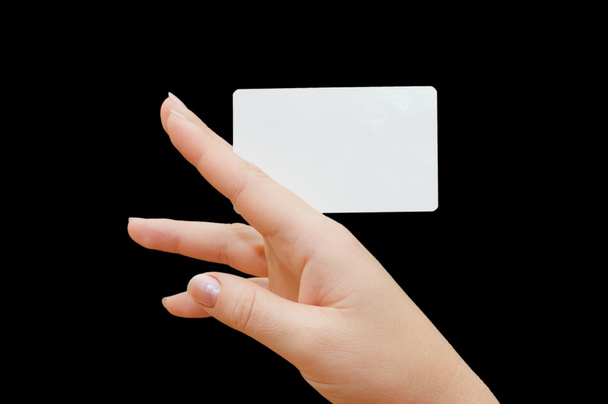 Paper card in woman hand on black background - Фото, зображення