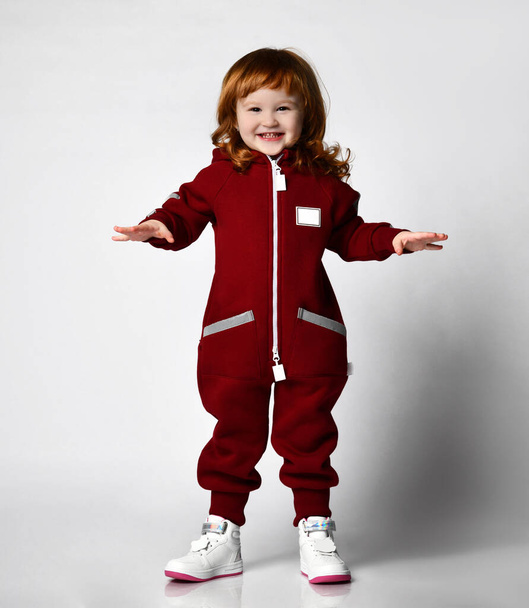 Cute red-haired girl in a comfortable tracksuit - Zdjęcie, obraz