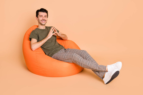 Full size photo of young handsome positive smiling businesswoman sit armchair relaxing isolated on pastel color background - Foto, Bild