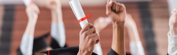 Cropped view of multiethnic students holding diploma near hands of blurred friends, banner  - Photo, Image