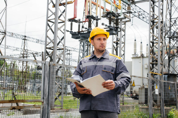 The energy engineer inspects the equipment of the substation. Power engineering. Industry - Photo, image