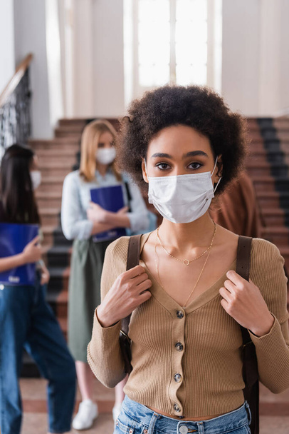 African american student in medical mask looking at camera in university  - Photo, Image