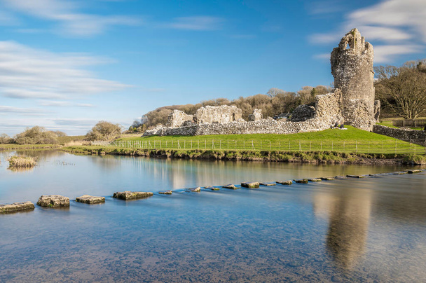Ogmore Castle, A ruined norman castle near Bridgend, south Wales.  The castle is reflected on the smooth water of the river Ogmore. - Photo, Image