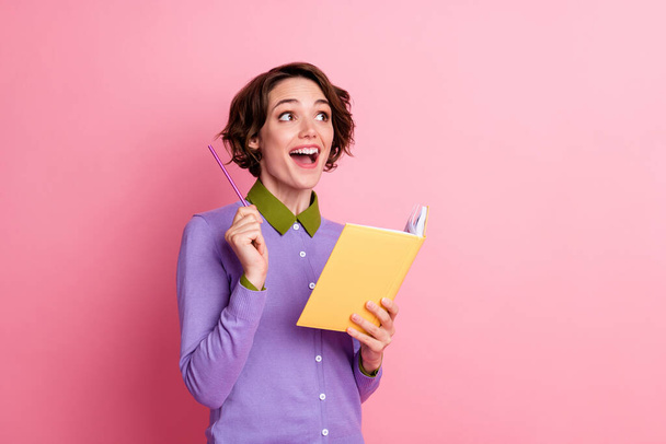 Photo of funny lady hold organizer thinking essay got creative idea wear purple jumper isolated pink color background - 写真・画像