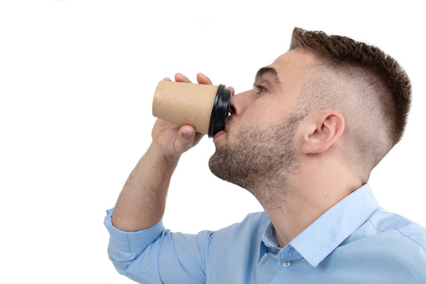 Close- up of a business-style guy drinking coffee. Fatigue at work - Φωτογραφία, εικόνα