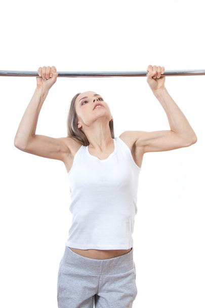 woman exercising on pull-up bar - Foto, imagen