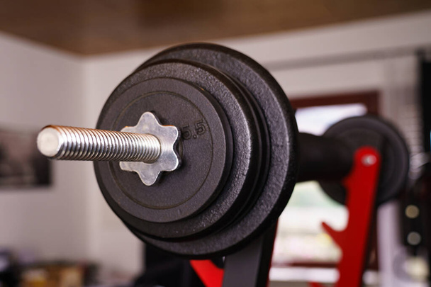 Sport equipment in gym. Close-up view of a barbells on a stand in the room. Selective fokus. - Photo, Image