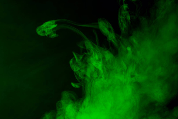 mystical cloud of green cigarette vapor close up bright fantastic abstraction mysterious pattern - Foto, Imagem