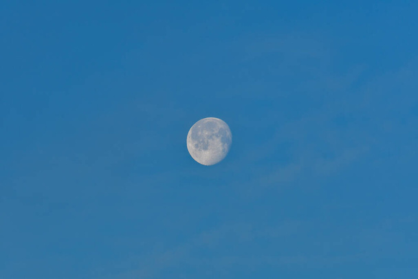 Uma lua de lobo, um satélite natural contra o céu azul. - Foto, Imagem
