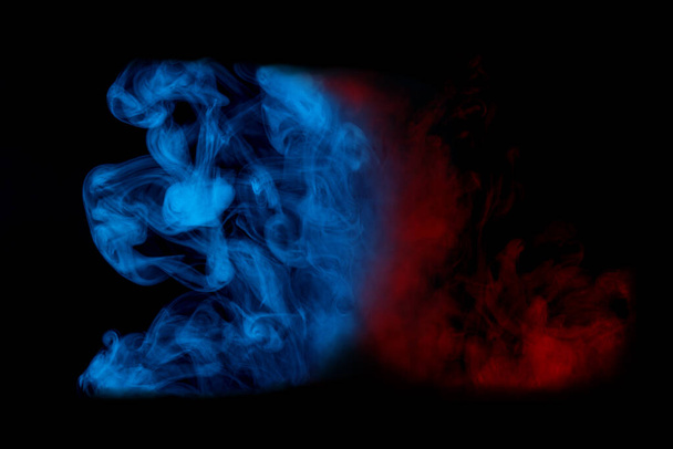 red cloud of cigarette vapor looks like a flame next to a fantastic blue pattern abstraction for design colored smoking concept - Photo, Image