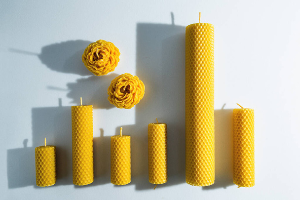 Decorative candles made of beeswax with a honey aroma for interior and tradition on the white background. - Photo, Image