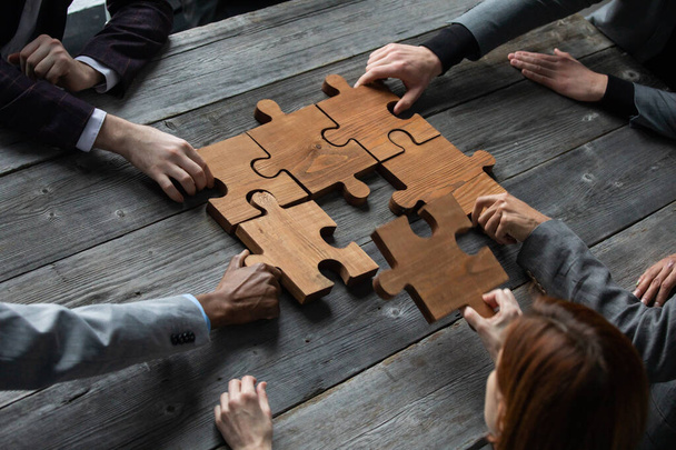 Business teamwork with puzzle finishing project cooperation unity concept - Photo, image
