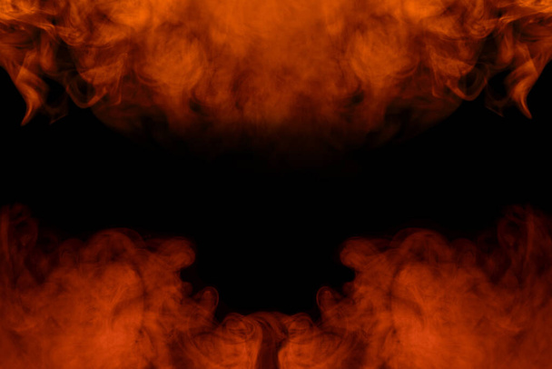 bright fiery abstraction cigarette orange vapor is like a fire close up on a dark background two charming clouds incredible patterns - Photo, Image