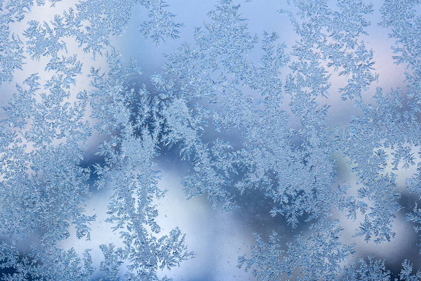 blue and shiny ice patterns on a frozen winter window background for design - Photo, Image