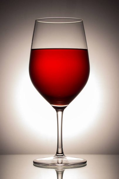 bright red wine drink of the gods in a beautiful glass on a spectacular gray background - Fotografie, Obrázek