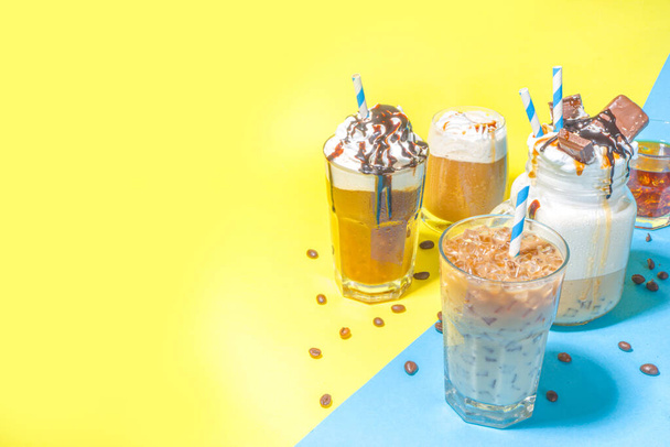 Set with different iced summer coffee drinks - espresso, frappe, latte, cappuccino, with whipped cream, syrup and crushed ice, in various glasses and  mugs on white background copy space - 写真・画像