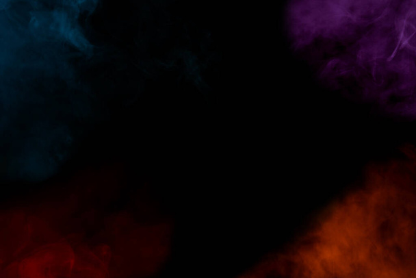 padrões coloridos de nuvens de vapor de cigarro em um fundo escuro de tirar o fôlego atmosfera misteriosa abstração - Foto, Imagem