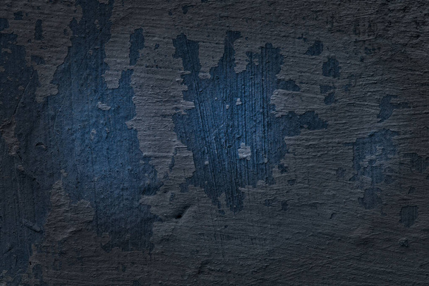 mysterious texture of a blue concrete wall with a peeled paint layer background for design - Fotó, kép