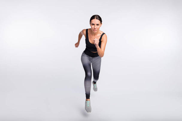Full length photo of brunette ponytail haired woman jump run endurance sport isolated on grey color background - Fotoğraf, Görsel
