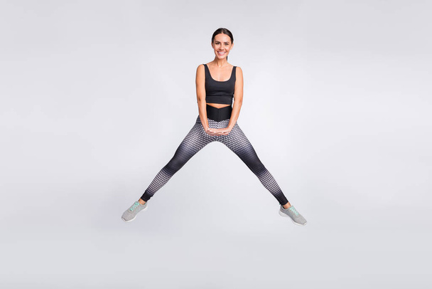 Full length photo of attractive active young woman gym athlete smile good mood isolated on grey color background - Φωτογραφία, εικόνα