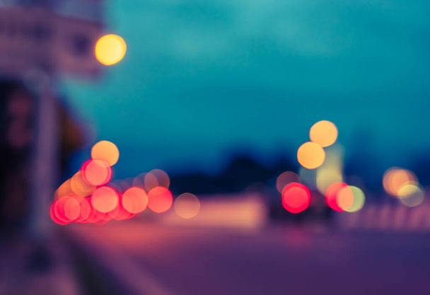 vintage tone image of blur car on road in evening time for background usage.(horizontal) - Foto, imagen