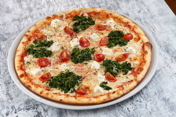 fresh pizza on white plate, close view  - Fotografie, Obrázek