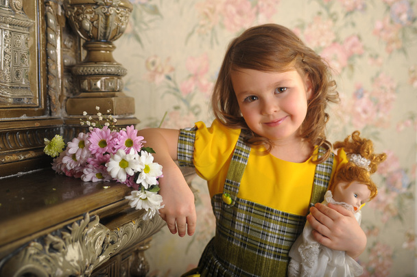 Little girl with a doll in hands. photos in retro style - Foto, Bild