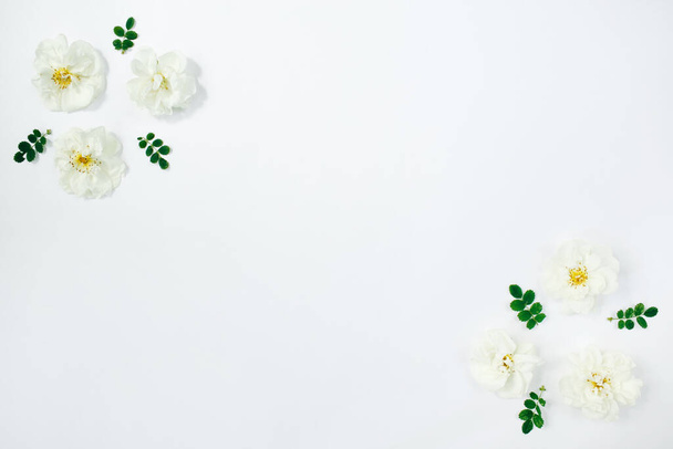 Floral composition. White flowers roses on white background. Spring, summer concept. Flat lay, top view, copy space - Fotó, kép