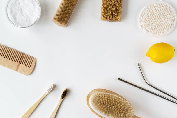 Wooden hair comb, face wash, hand made oatmeal soap, soda, lemon, metal drink straws, brush, bamboo toothbrushes. Eco friendly stuff concept. Horizontal orientation. Top view. Copy space.  - Zdjęcie, obraz