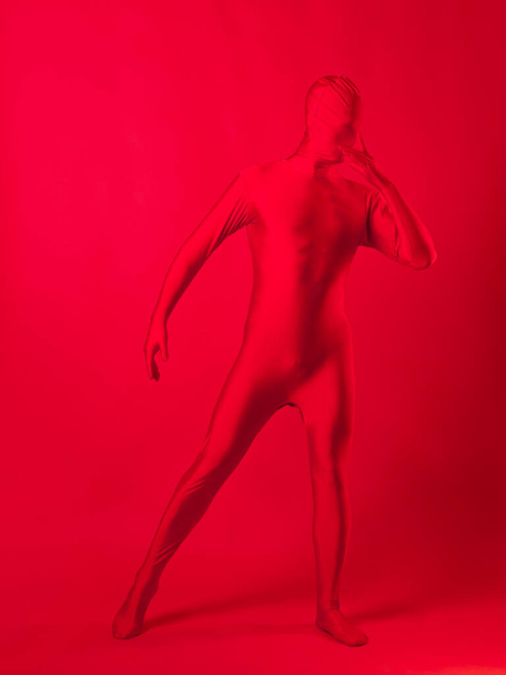 crazy red man on a red background. figure in a leotard covering the whole body - Photo, Image