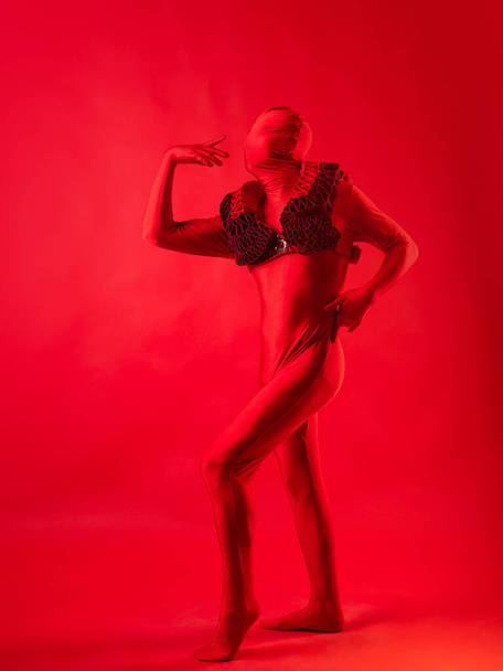 crazy fashion, a man in a red leotard on a red background, - Foto, Imagem