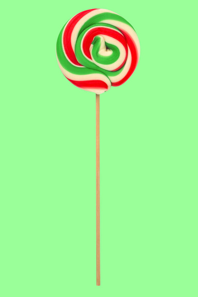 Sweet colourful Lollipop isolated over green background - Photo, Image