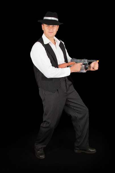 Dangerous gangster with 1920 style clothes standing with gun - Fotoğraf, Görsel