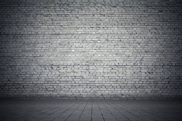 Empty room with bricks wall and tiled floor. Dark background. - Photo, Image