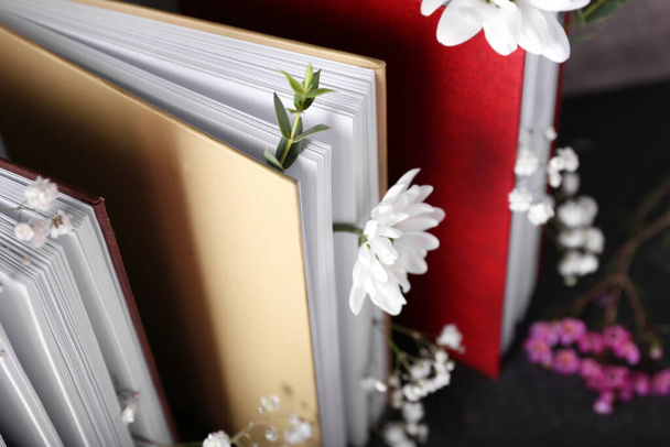 Books with floral decor, closeup - 写真・画像