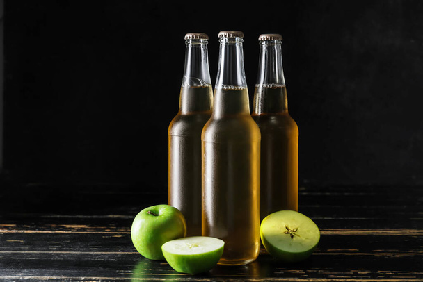 Bottles of apple cider on dark background - Photo, image