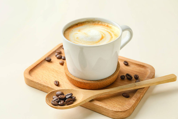 Cup of hot cappuccino coffee on light background - Photo, Image