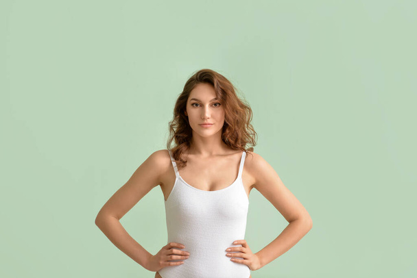Beautiful young woman in swimsuit on color background - Φωτογραφία, εικόνα