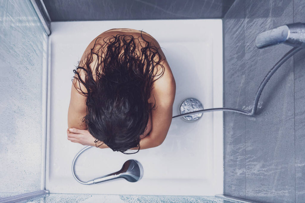 Adult woman under the shower in bathroom - Фото, изображение
