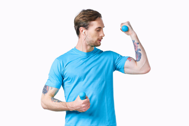 macchina con tatuaggi sulle braccia e manubri blu fitness culturisti - Foto, immagini