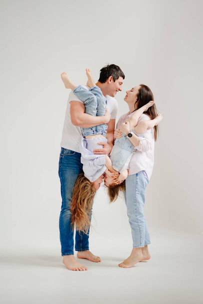 beautiful happy family at a photo shoot in a white photo studio. backstage. - Zdjęcie, obraz